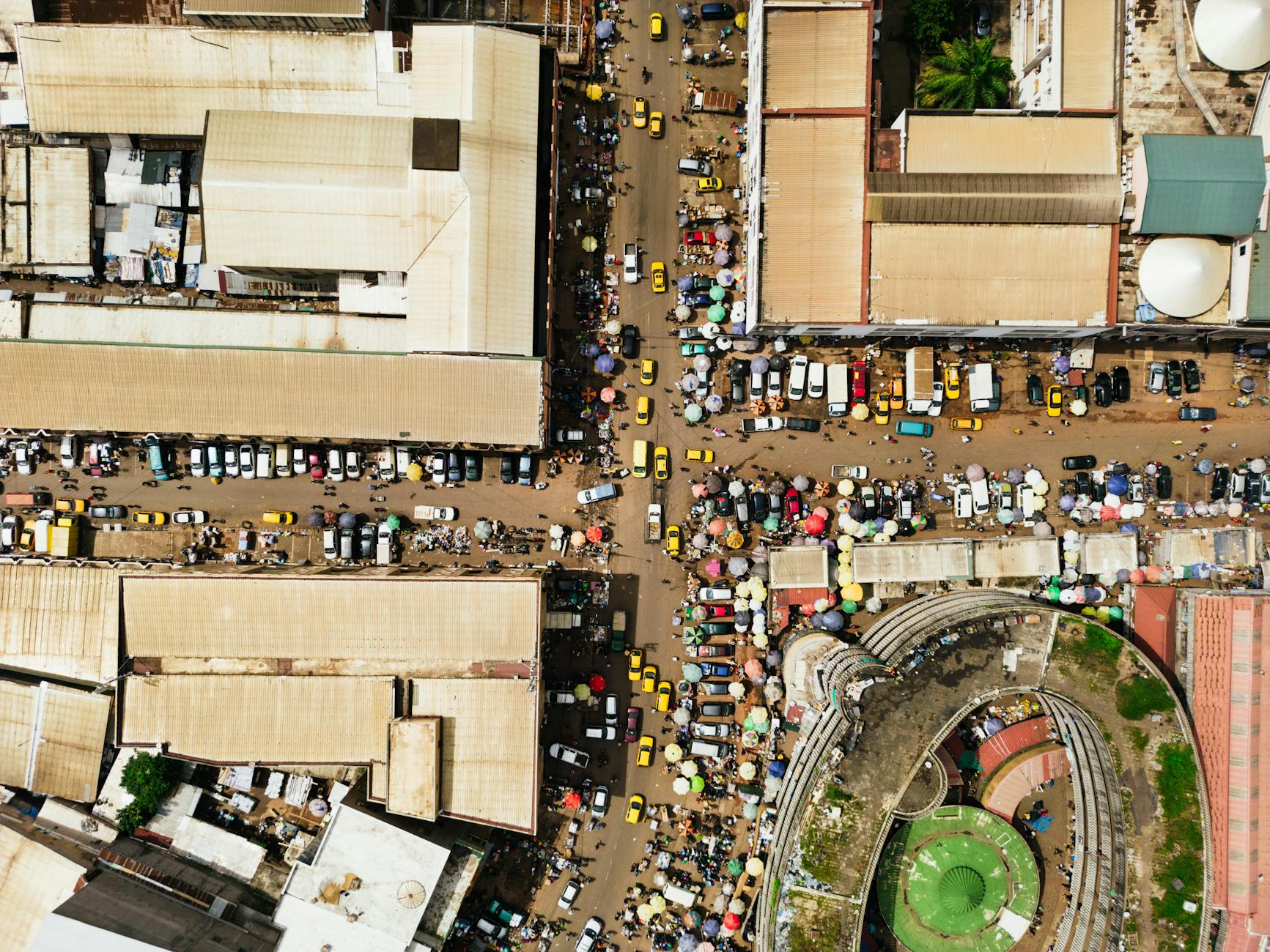Aerial view of a bustling market in Nigeria, reflecting the vibrant culture and daily life of the Ibo people.