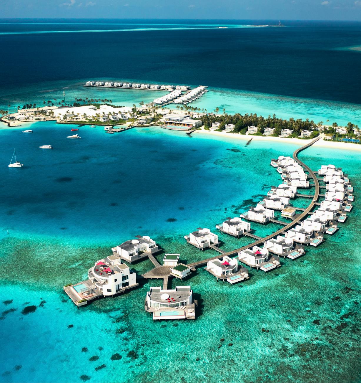 Aerial view of luxury overwater villas in the turquoise waters of the Maldives, showcasing the stunning natural beauty of the island nation.