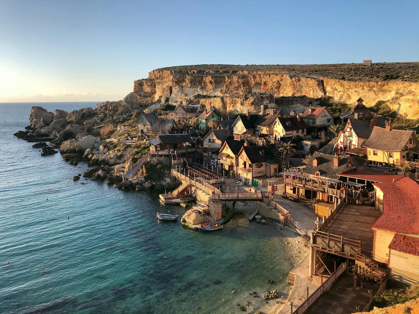 A picturesque coastal village in Malta, showcasing traditional architecture and crystal-clear waters.