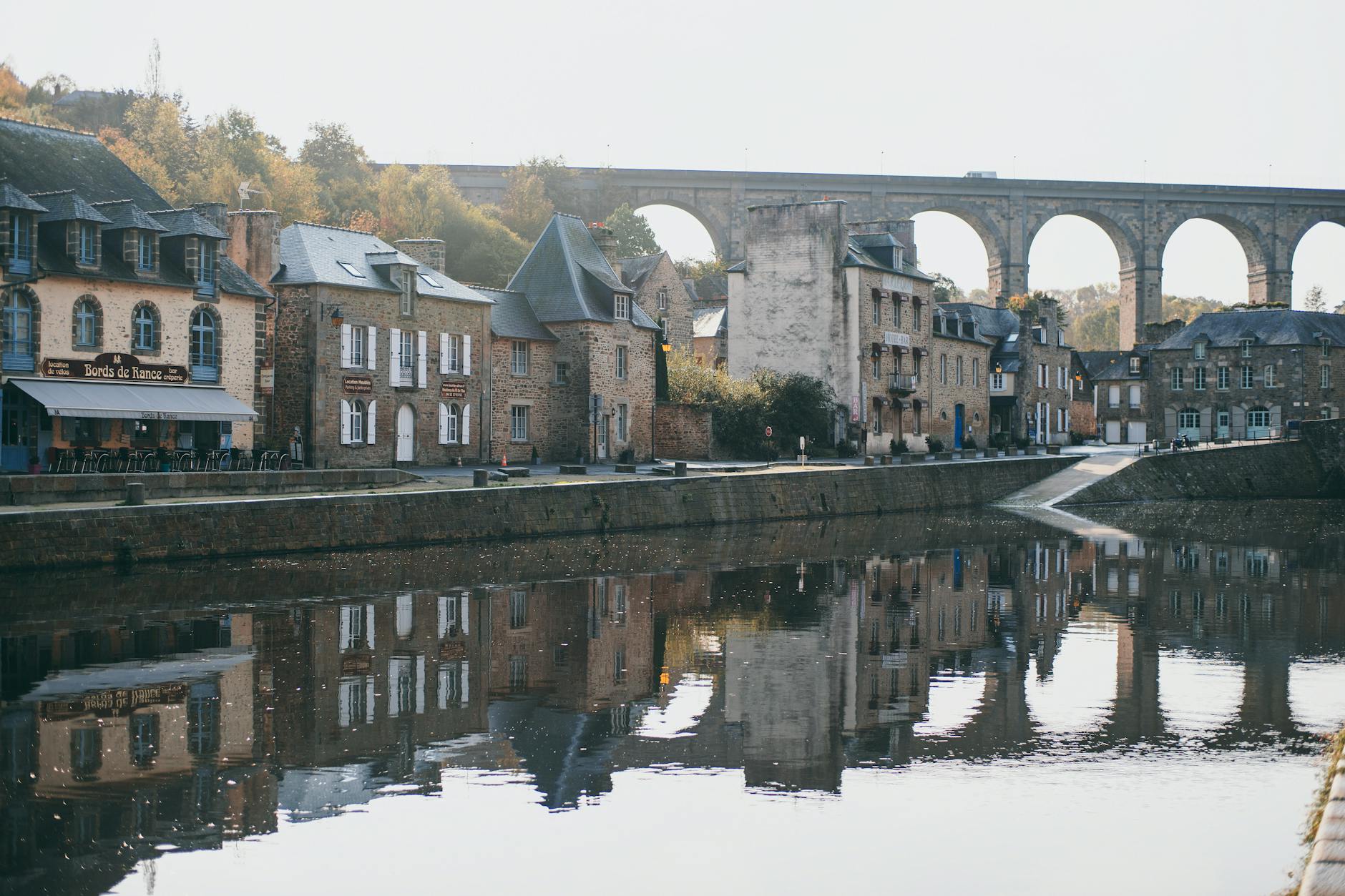 A picturesque view of a canal lined with historic buildings in Brittany, France, highlighting the cultural richness and heritage of the Breton-speaking region.