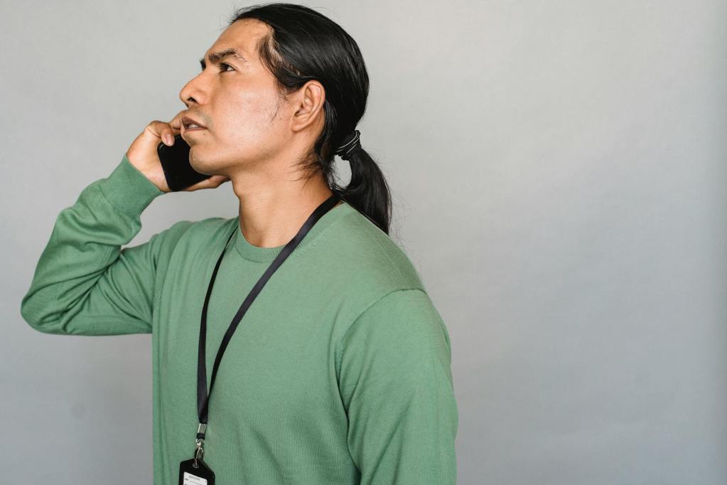 Professional Mohawk language translator speaking on the phone, symbolizing the importance of language preservation and effective communication in indigenous languages.
